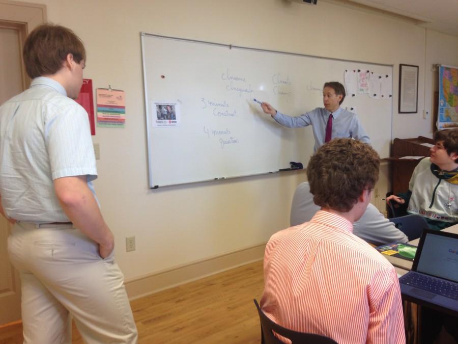 Dr. Kostandarithes, sponsor of the Young Republicans, guides the club through deciding roles for the upcoming debate.