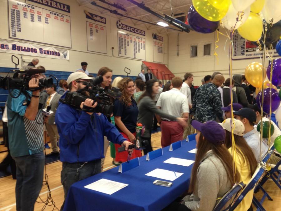 Students congratulate the seniors as their signings are publicized. 