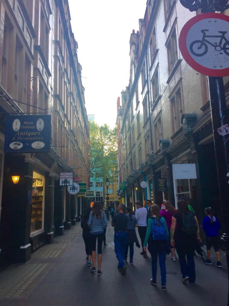 Cecil Court has many old bookshops and antique stores lining the street. Some of the visitors from the Harry Potter tour walk around, enjoying the character of each building and glancing in the shop windows.