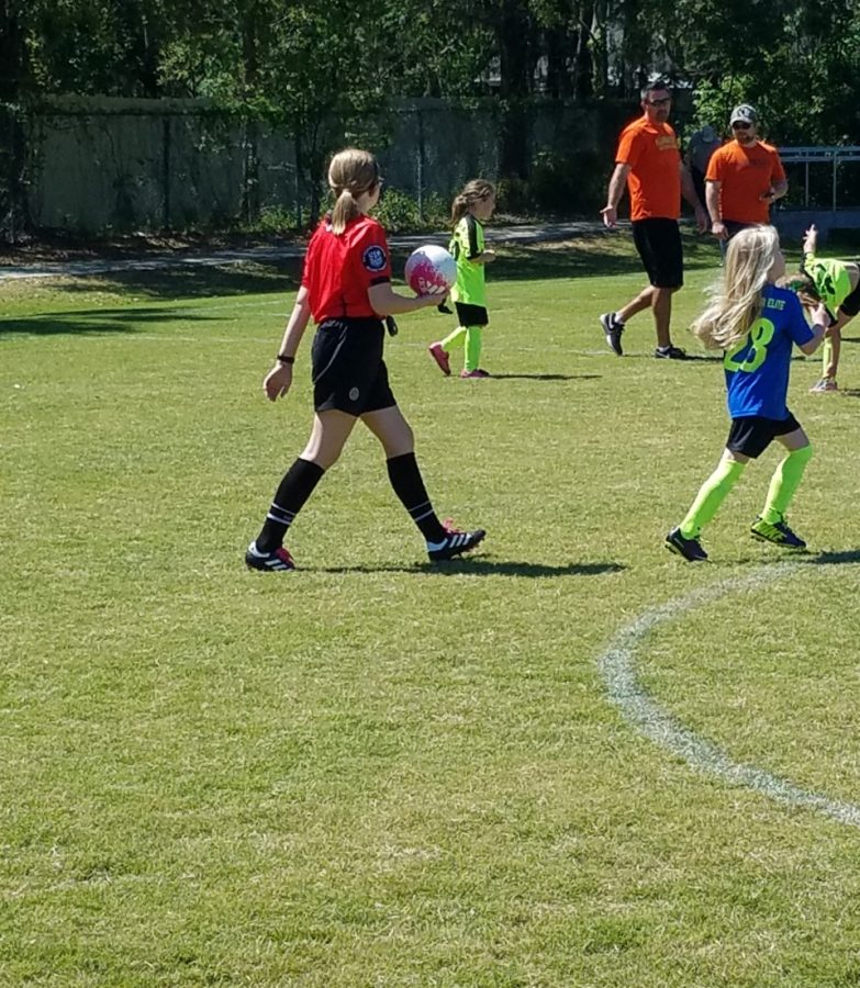 Sophie Grace holds the soccer ball after making a call. (Credit: Posick)