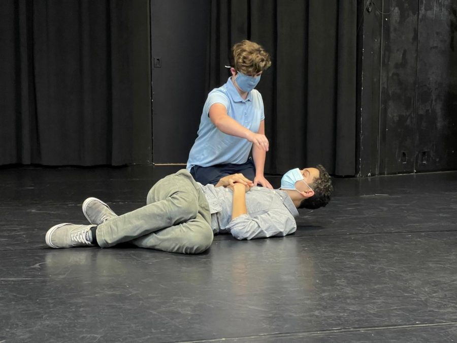 In rehearsal, Titania (Grace Maroon) pours nectar from a flower into Oberon’s (Kris Stam) eyes.