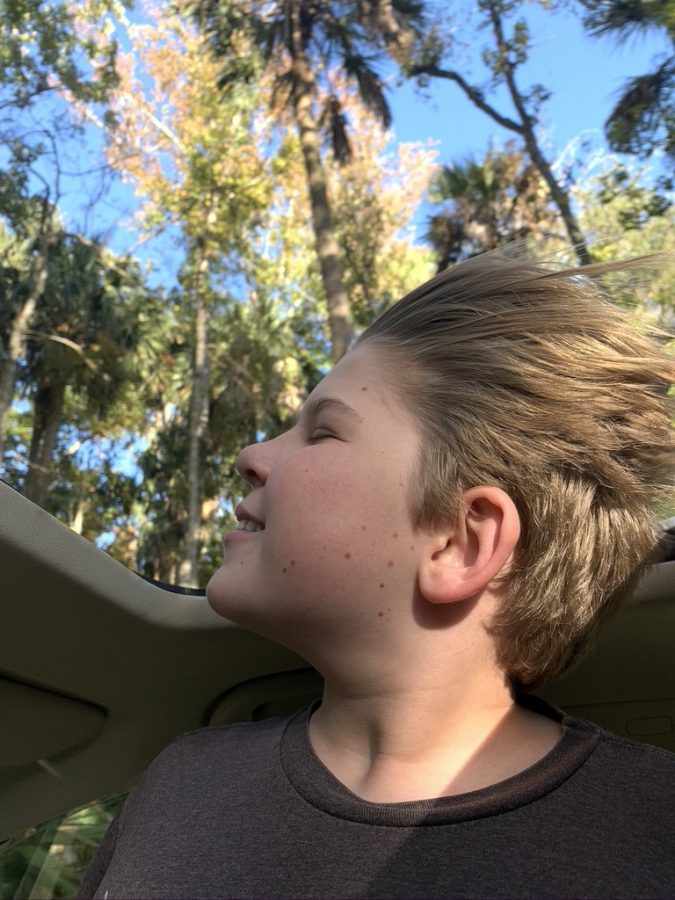 My brother hanging out of the sun roof of the car after an adventure at
Daytona Beach.