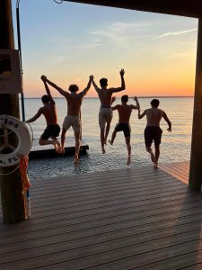 Boarders jump off the Bolles dock into the Saint Johns River.